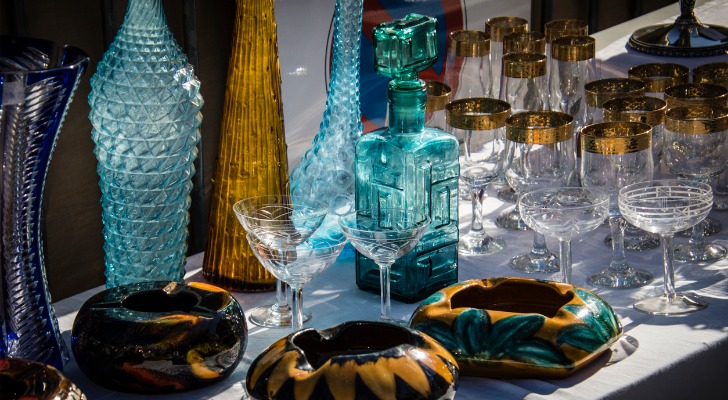 Glassware and other items are displayed during an estate sale.
