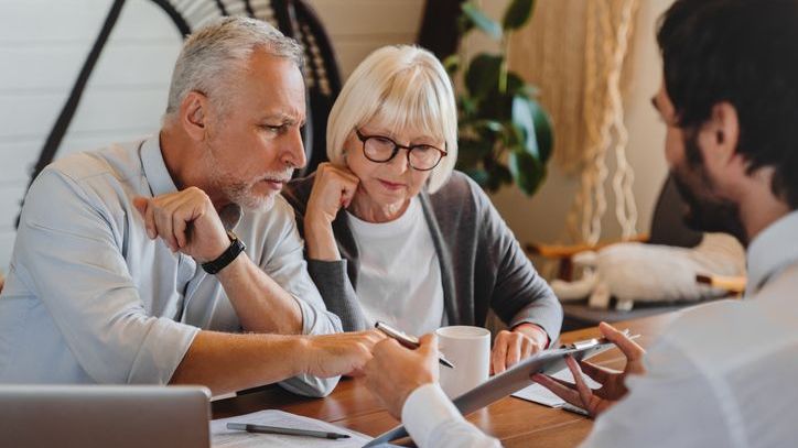 A retired couple meets with their financial advisor to discuss their income plan. 