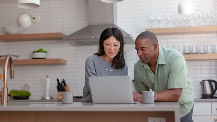 A woman and her husband look over their IRA balances as they talk about their plan for retirement.