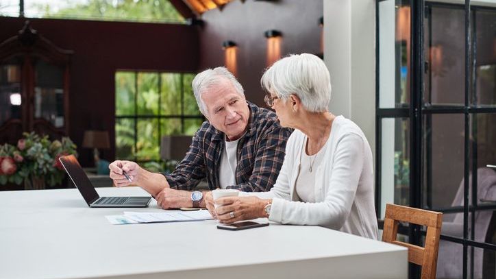 A couple reviews their will as they discuss their estate plan. 