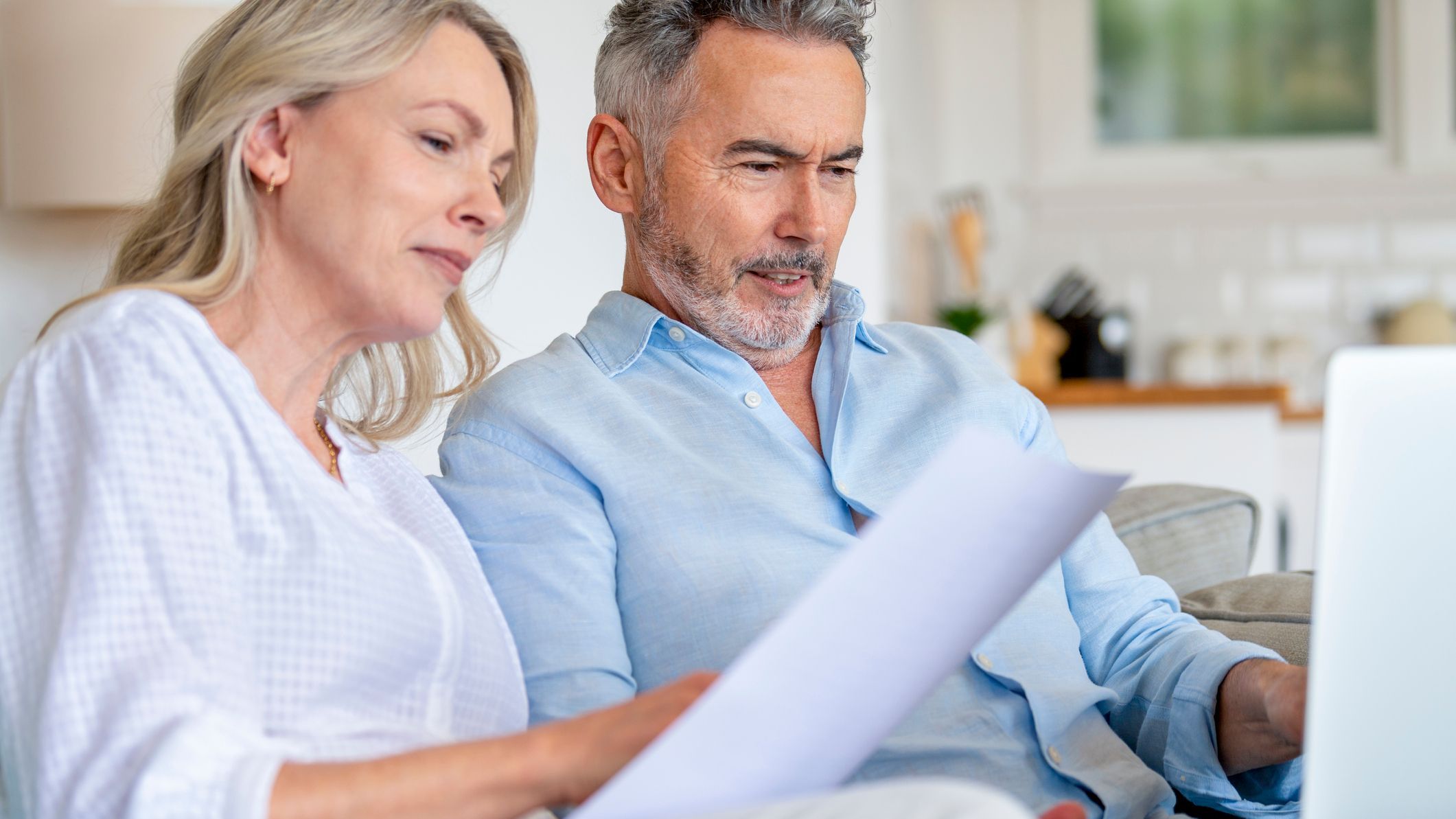 A married couple looks over their retirement savings to determine whether it makes sense to switch to Roth contributions. 