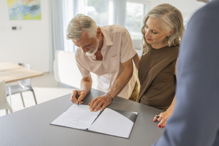 A senior couple signing a financial power of attorney in Wisconsin.