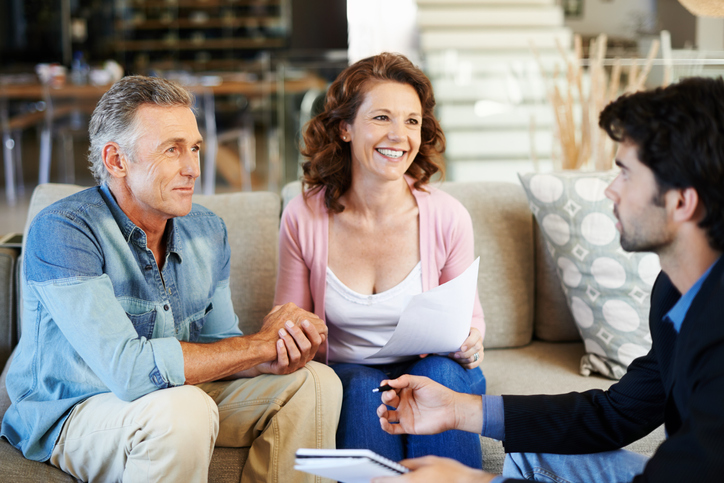 A couple meets with a financial advisor to discuss creating a will and a trust in North Carolina.