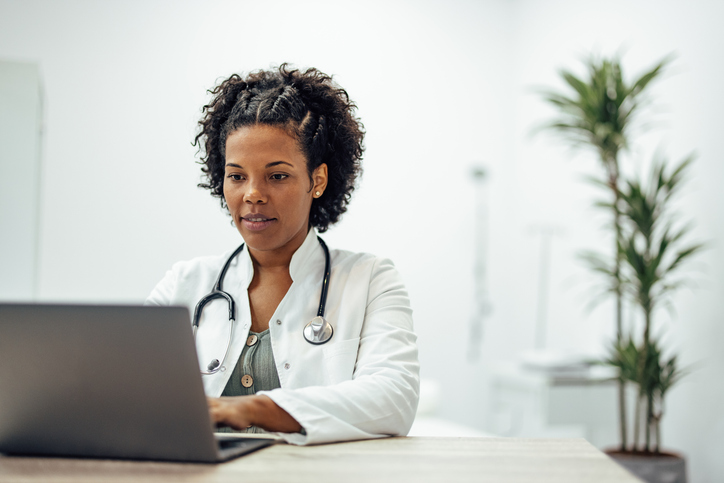 A physician managing her finances online.