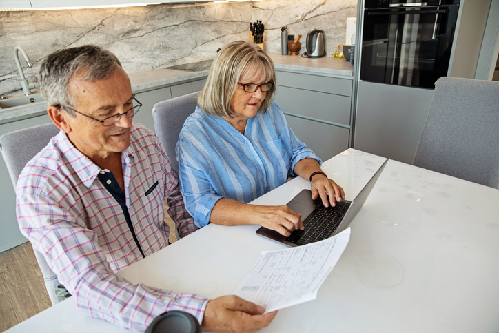 A senior couple reviewing an estate planning checklist to help them avoid probate.