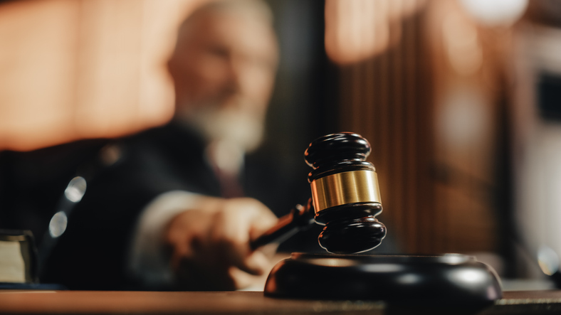 A judge bangs his gavel during a divorce proceeding.
