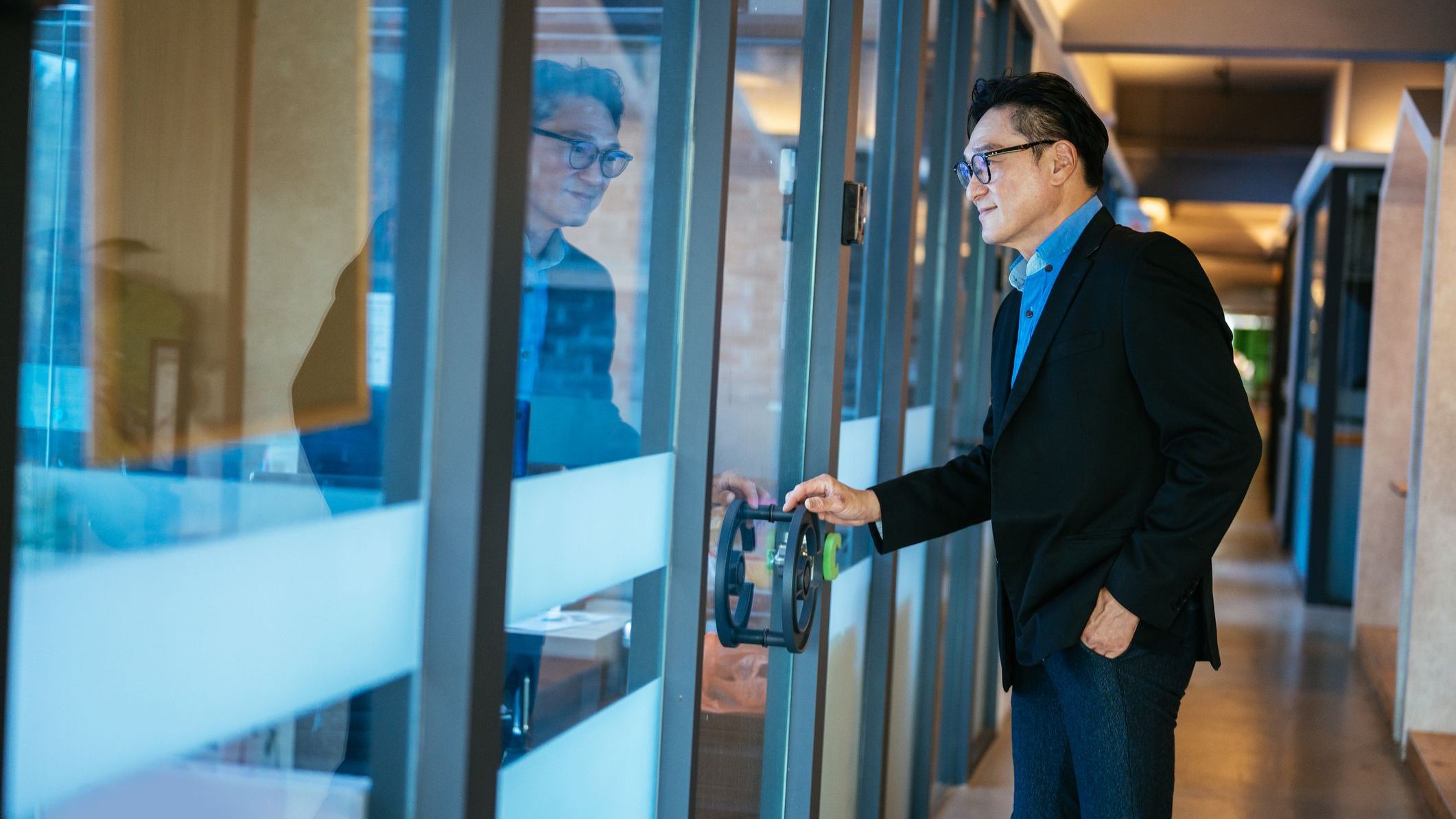 A financial advisor opens the door to his new office at the RIA firm he recently joined.