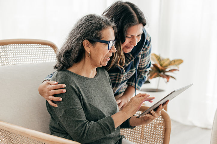 Mother and daughter looking up the cost of long-term care insurance at age 60 and beyond.