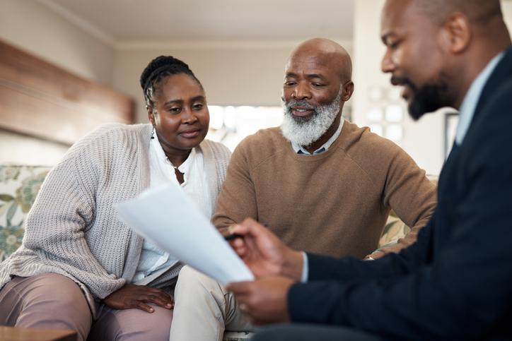 A senior couple meeting with a financial advisor to discuss their retirement plan.
