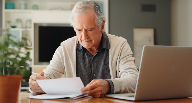 A senior reading the terms of a reverse mortgage.