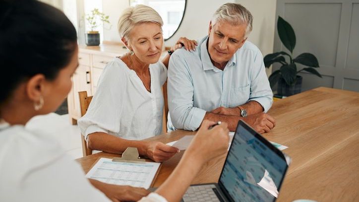 A couple nearing retirement age meets with a financial advisor who specializes in retirement planning.