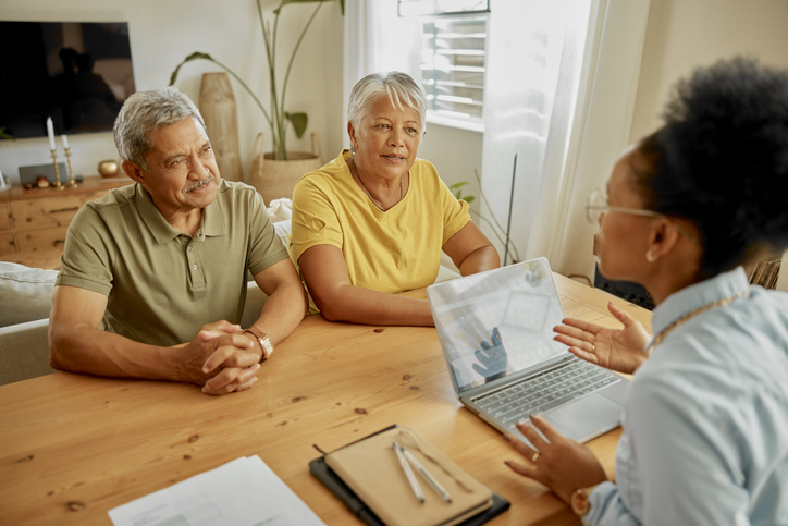 A financial advisor meeting with a senior couple to help them create an estate plan.