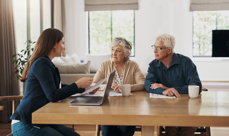 A senior couple meeting with a financial advisor to discuss tips for their retirement plan.