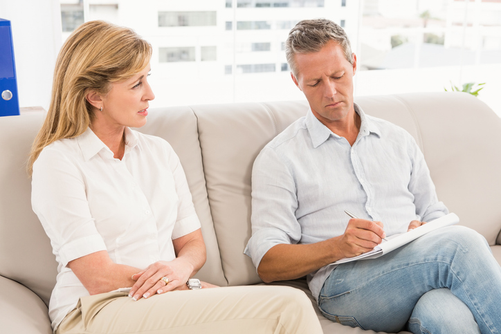 A couple making a list of tax strategies to discuss with a retirement planner.