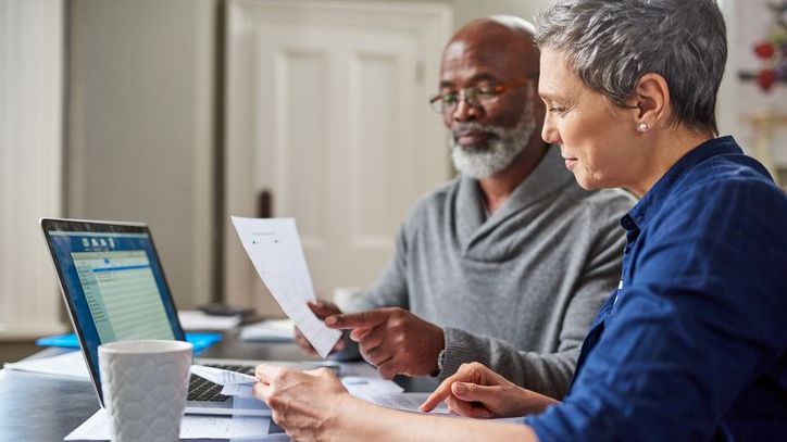 A couple reviews their retirement accumulation plan by looking over how much they're each contributing to their retirement savings accounts.