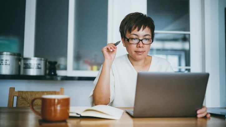 A woman looks over her Roth IRA balance and investments. 