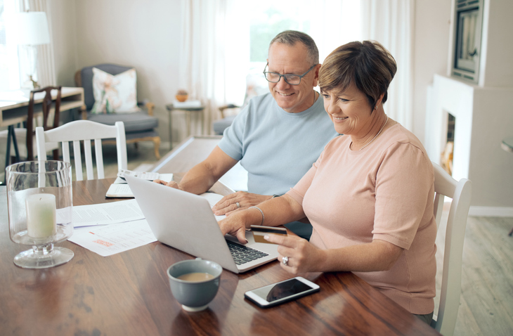 A senior couple researching strategies to protect their retirement income.