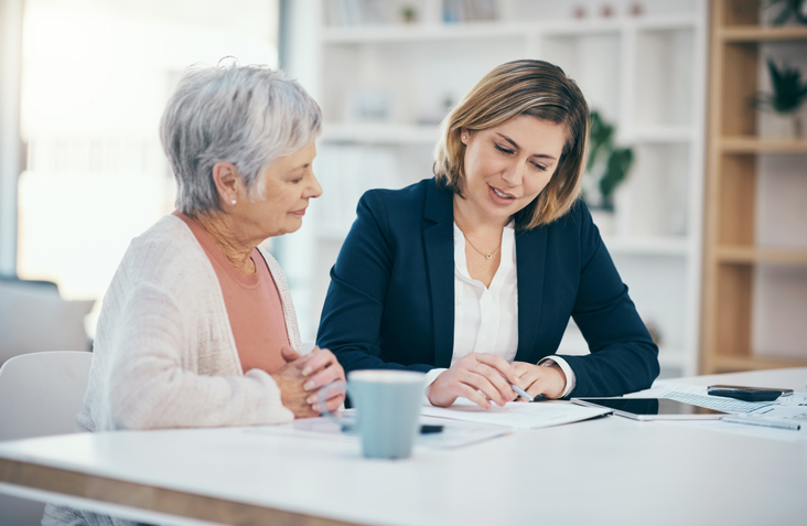 A senior meeting with a financial advisor to discuss different types of annuities.