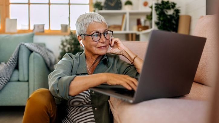 A woman looks over her retirement portfolio on her laptop. 