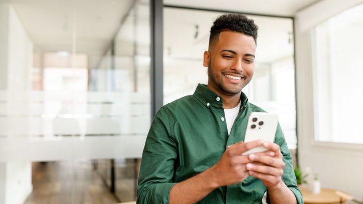 A young investor uses his phone to purchase a fractional share of a company.