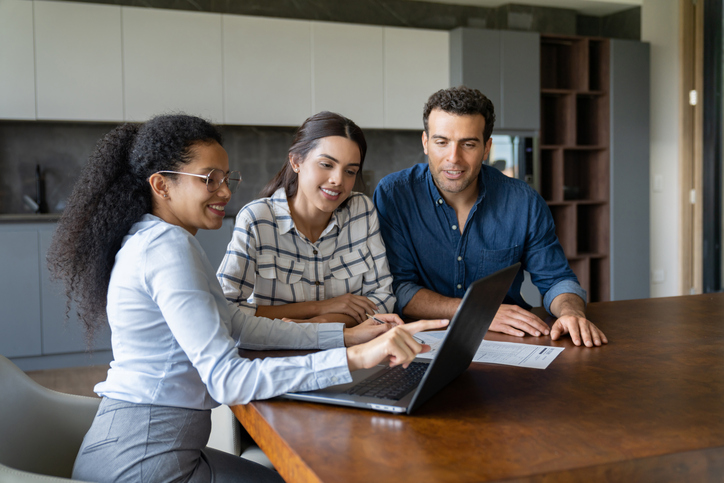 A financial advisor working with clients after connecting through a sales pitch.