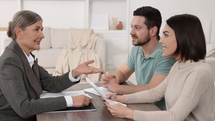 A couple meets with a certified financial planner (CFP) professional to discuss their financial plan.