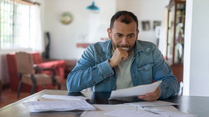 A man facing financial hardship considers a 401(k) hardship withdrawal.