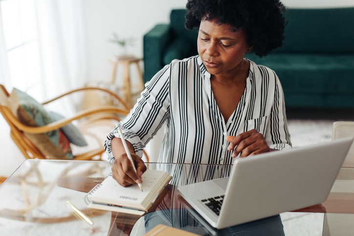 A woman researching how permanent life insurance policy can be a source of tax-advantaged savings and income for retirement.