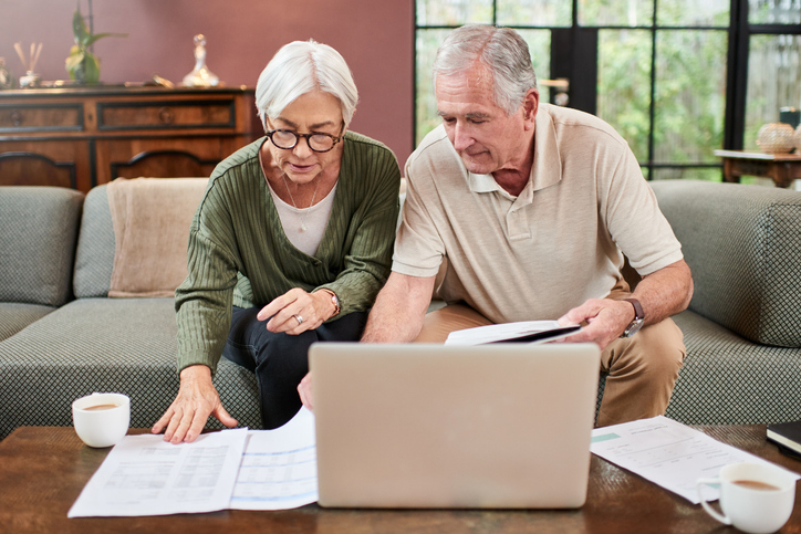 A senior couple reviewing their financial power of attorney in Massachusetts.