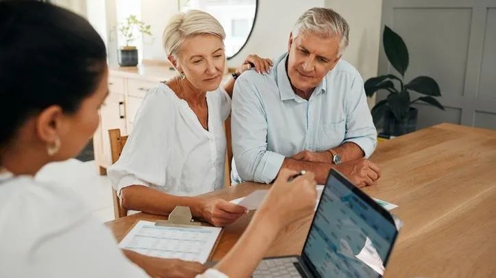 A retired couple meets with their financial advisor for retirement planning.