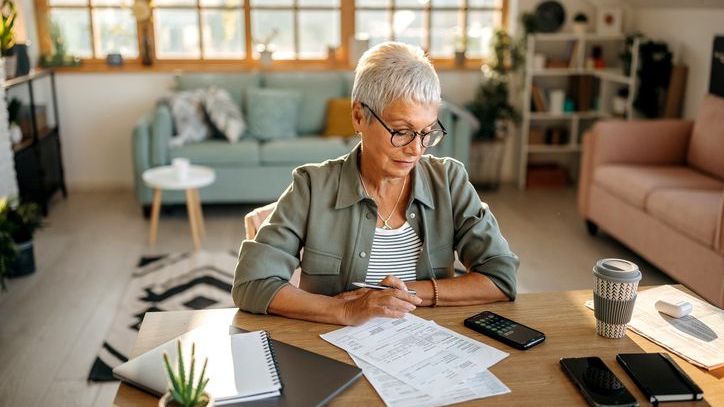 A woman who approaching retirement looks over her finances. 