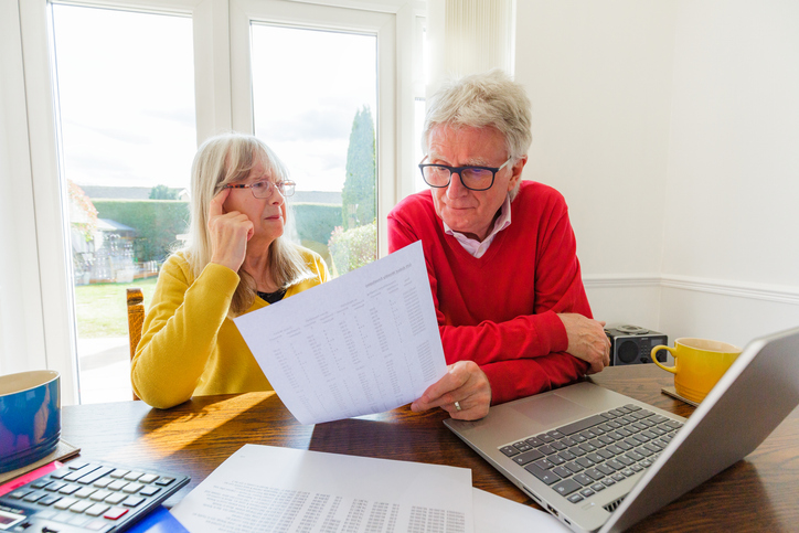 A senior couple researching how to lower retirement taxes with life insurance.