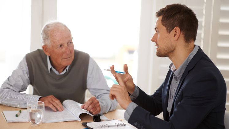 A retiree meets with his financial advisor to discuss Roth conversions and their impact on RMDs.