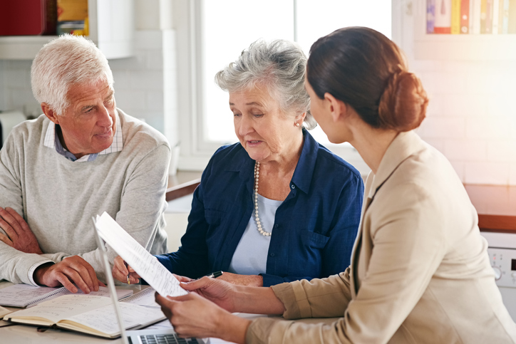An unmarried senior couple meeting with an advisor to discuss their estate planning options.