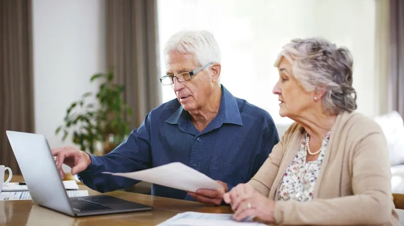 A senior couple reviewing their financial power of attorney in Kentucky.