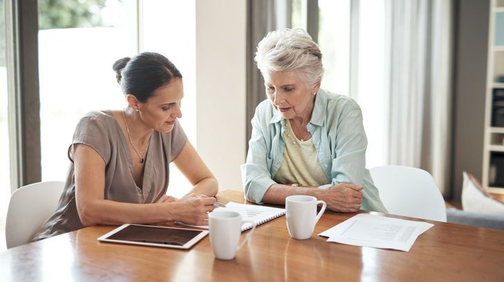 A woman meets with an estate planner to work on her succession plan.