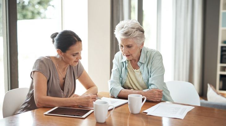 A retiree works with her financial advisor on a plan to reinvest her RMD income. 