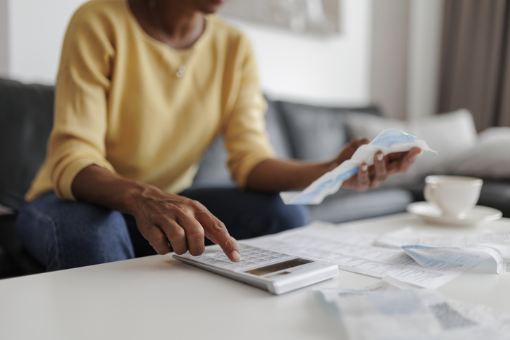 A woman reviews her budget as inflation rises. 