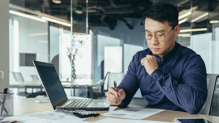 A finance professional who's exempt from registering with the SEC works at his desk.