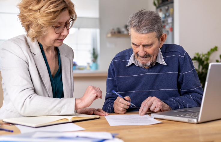 A man filling out forms for power of attorney in Florida. 