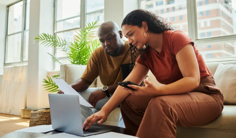 A couple reading the terms of a CD investment.