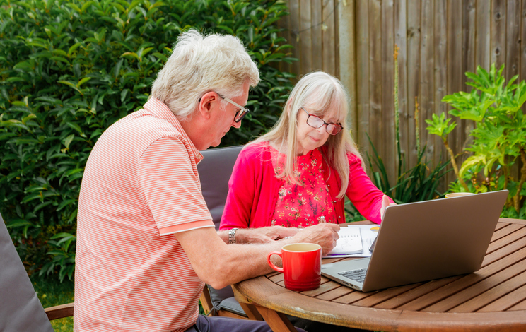 A couple reviewing their wealth management estate planning documents.