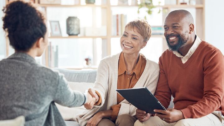 A couple meets with their financial advisor. As fiduciaries, financial advisors have a duty of loyalty to their clients.