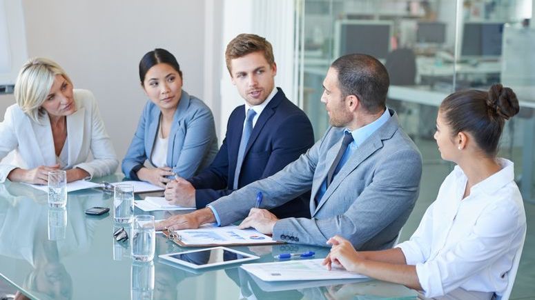 The board of directors of a company discusses the business during a meeting.