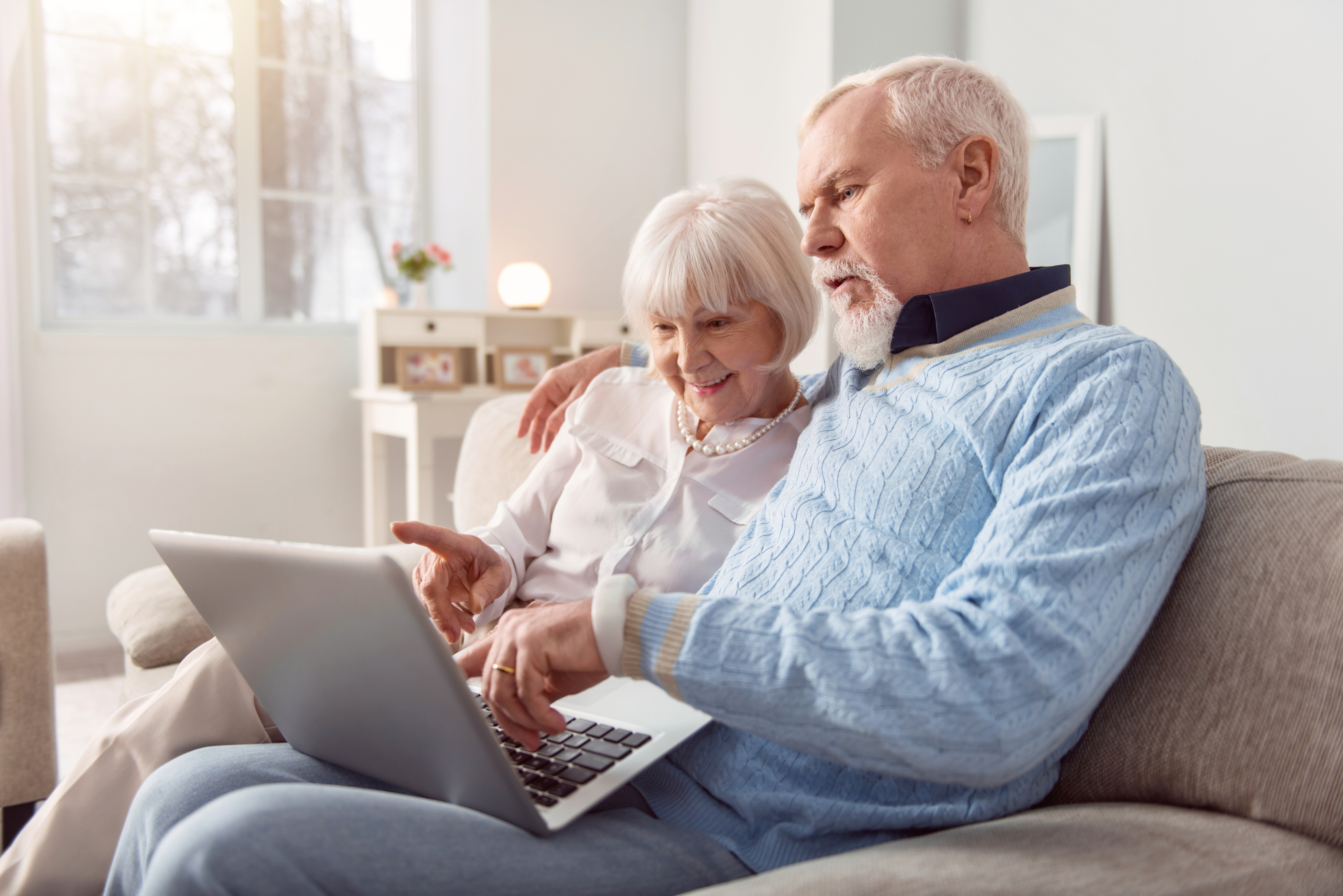 A senior couple reviewing income from their retirement portfolio.