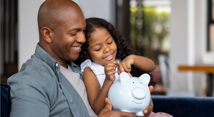 A father explains the importance of saving money to his daughter.