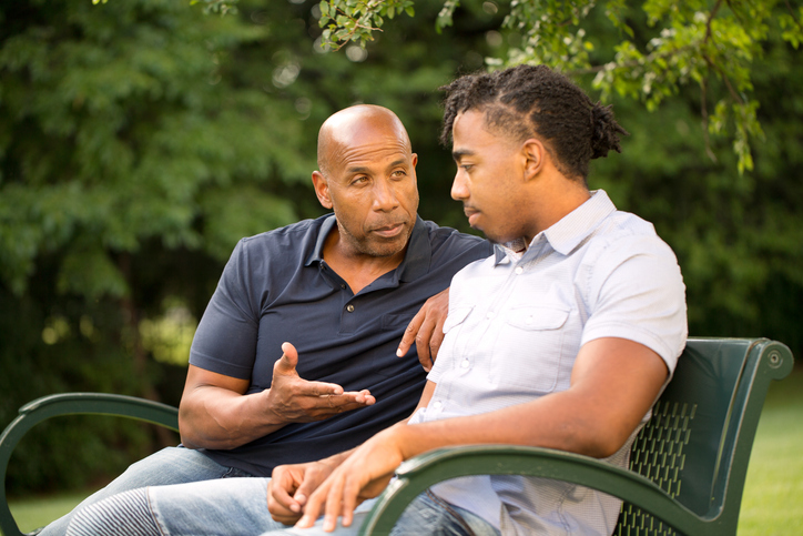 A father discussing an estate plan with his son.