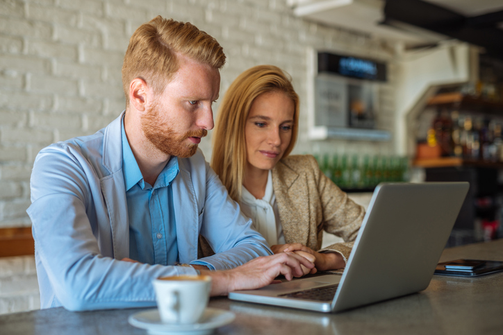 A couple researching the benefits and drawbacks of debt consolidation.