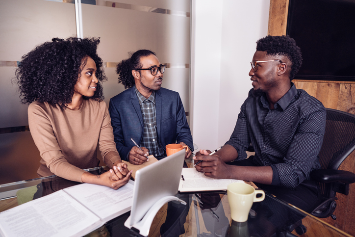 A couple meeting with an attorney to file a small estate affidavit.