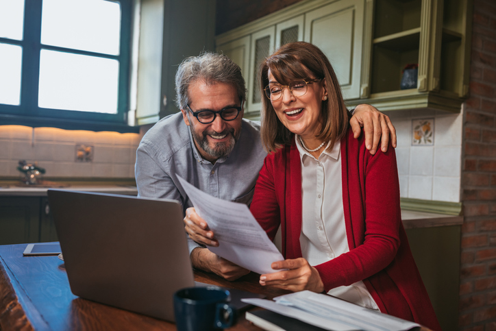 A senior couple reviewing their estate plan at home.